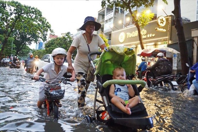 Người dân ở "khu nhà giàu" Thảo Điền bì bõm lội nước sau cơn mưa. Ảnh: M.Q 