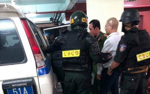 Nguyễn Thái Luyện áp giải ra xe công vụ /// Ảnh: CTV