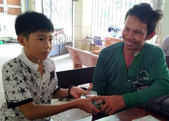 Em Hồ Thiế Thuận trao lại số tiền nhặt được cho ông Phan Thanh Nhàn. Ảnh: An Phú 