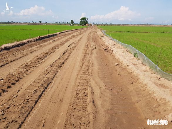 Cho chính quyền mượn đất mở đường giữa đồng lúa giúp dân vùng sạt lở đi lại - Ảnh 1.