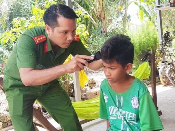 Đại úy Thạch Bình cắt tóc miễn phí cho trẻ em nghèo trong xóm /// DUY TÂN