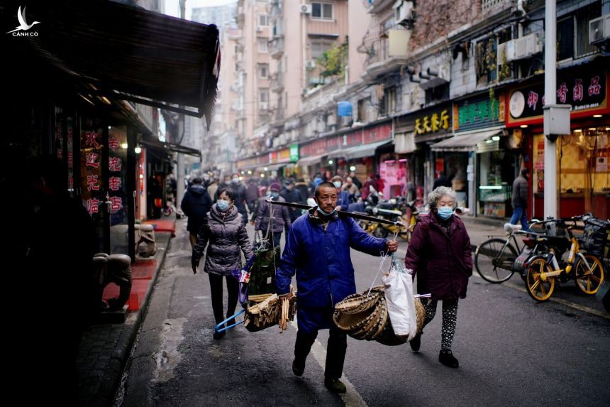 Người dân đi lại tại một khu chợ ở Vũ Hán, Trung Quốc ngày 7/12. Ảnh: Reuters.
