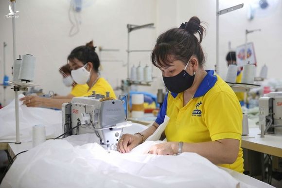 Công nhân Công ty TNHH may mặc Dony (Q.Tân Bình, TP.HCM) sản xuất áo chống dịch xuất khẩu /// ẢNH: HOÀNG TRIỀU