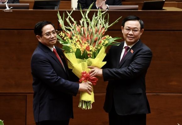 Thủ tướng Phạm Minh Chính nhận hoa từ Chủ tịch Quốc hội Vương Đình Huệ tại lễ tuyên thệ nhậm chức. 