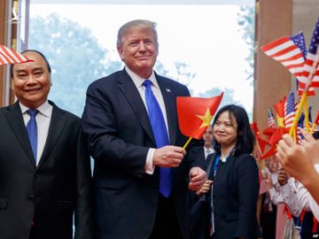  Tổng thống Mỹ Donald Trump vui tươi cằm cờ Việt Nam, trên đất nước Việt Nam phần nào cho thấy được vị thế của Việt Nam hôm nay