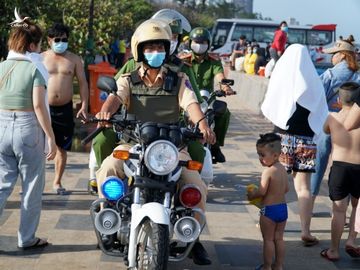 Cảnh sát tuần tra liên tục trên bờ kè biển Bãi Sau để nhắc nhở người dân đeo khẩu trang, không được xuống biển. Ảnh: Trường Hà.