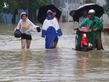 Người dân Nha Trang dắt xe, đi bộ qua khu vực ngập. Ảnh: Xuân Ngọc.