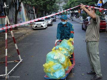 Chính quyền tiếp tế thực phẩm cho cư dân bị phong tỏa, cách ly ở chung cư. Ảnh: Đình Văn.