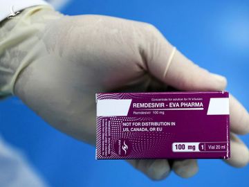 Một kỹ thuật viên phòng thí nghiệm cầm hộp thuốc kháng virus Remdesivir, được sử dụng để điều trị Covid-19, tại Cairo, Ai Cập, hôm 1/6. Ảnh: Reuters.